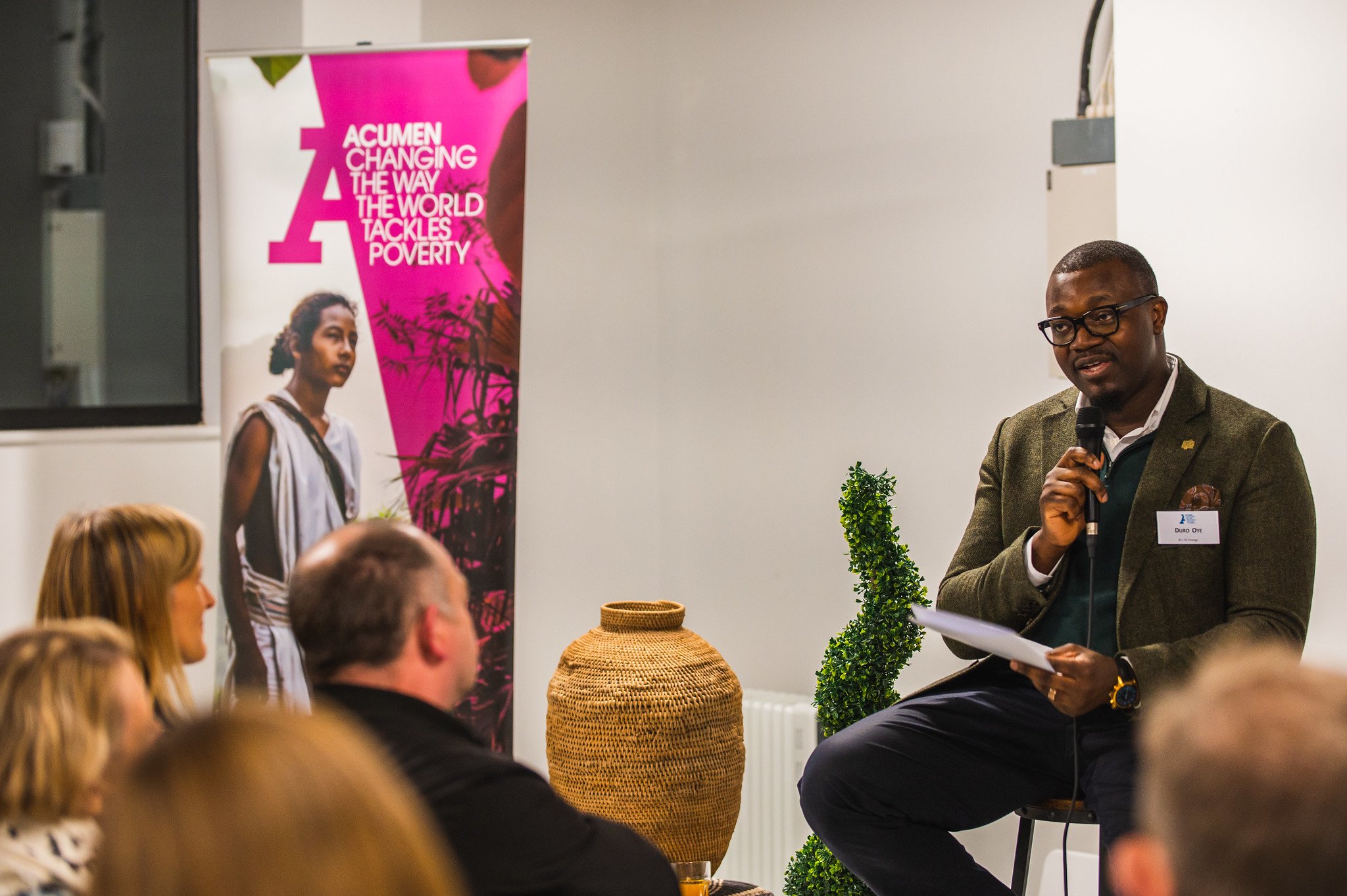 Duro in front of a crowd talking with a microphone