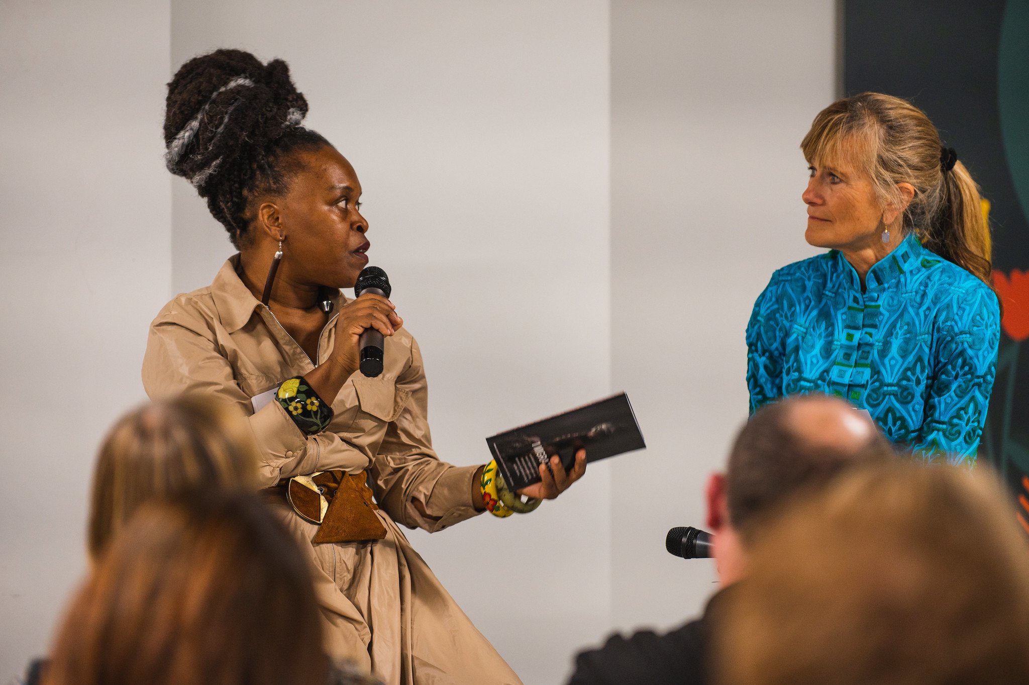 Laura and Jacqueline in conversation with microphones Laura and Jacqueline in conversation with microphones