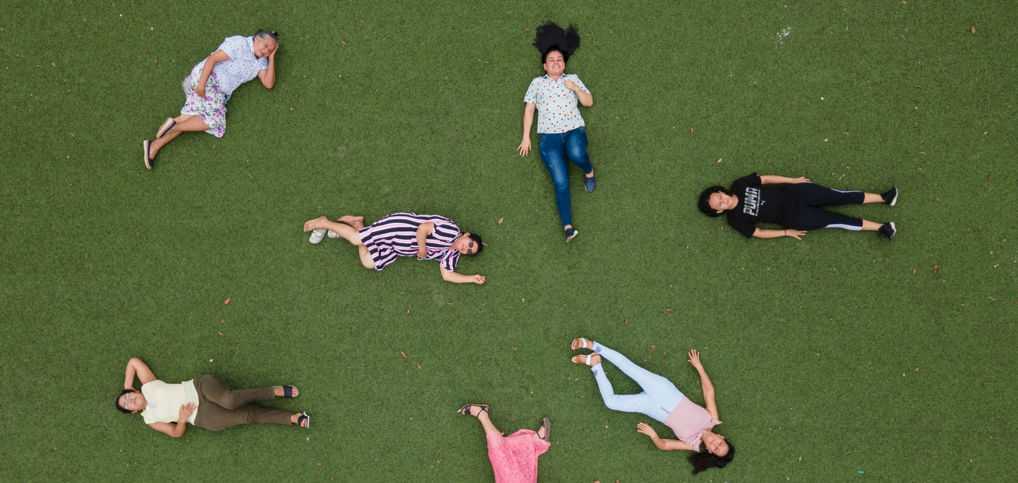 People lying down on grass