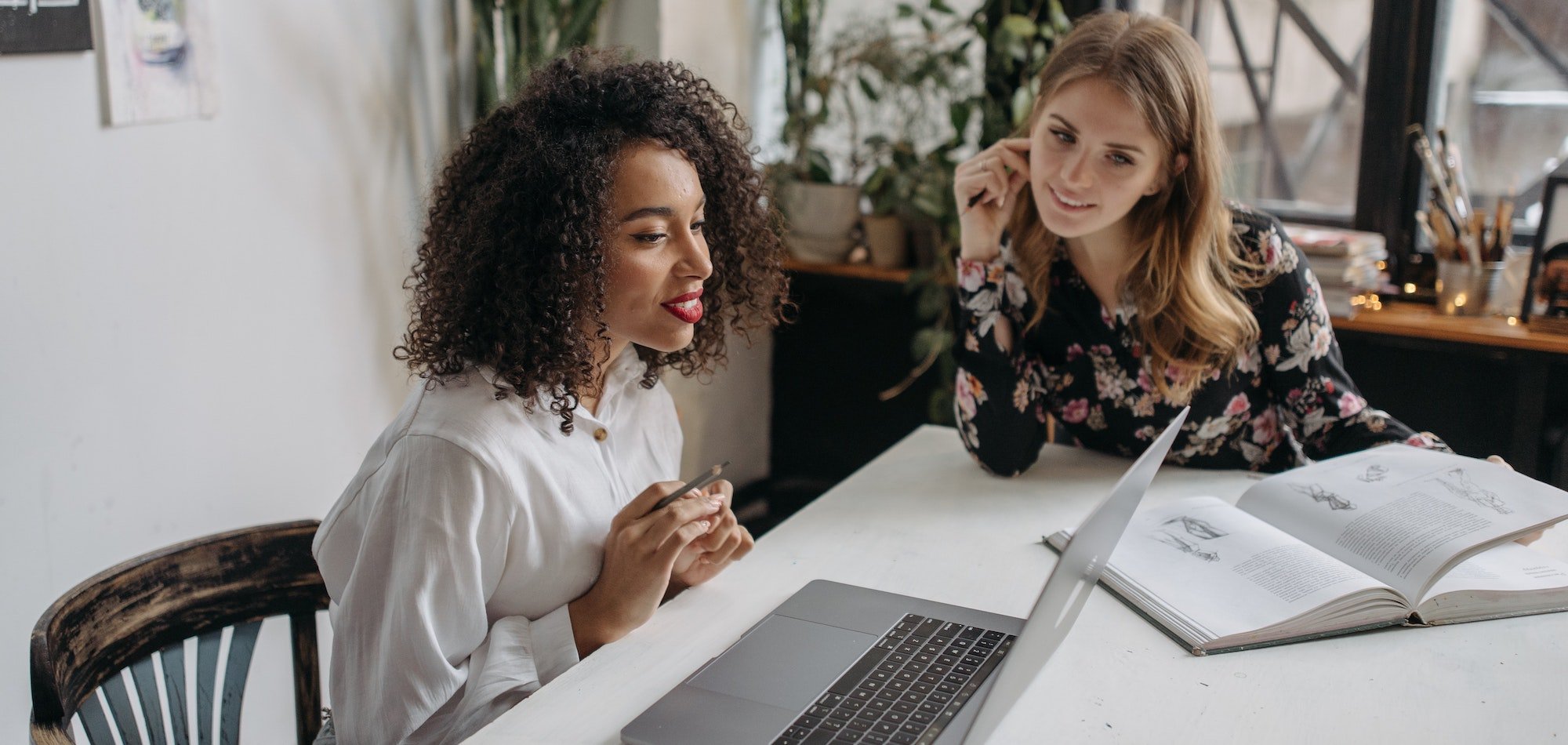 Two women looking. at a laptop